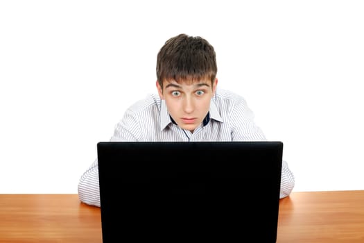 Surprised Teenager with Laptop on the Desk. Isolated on the White Background