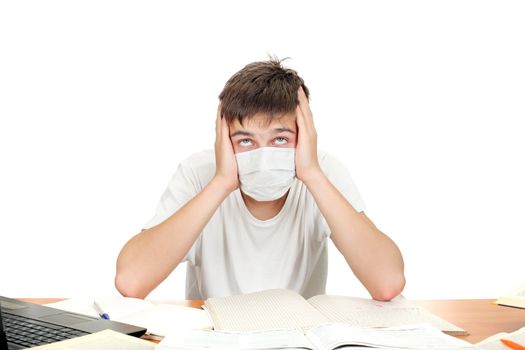 Diseased student in flu mask at the school desk. Isolated on the white background