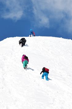 A Rope Team of Mountaineers Climbs Towards the Summit 