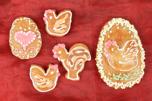 Easter gingerbreads rooster and hen on red background