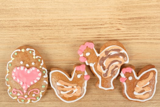 Easter gingerbreads rooster and hen on wooden background