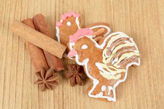 Easter gingerbreads and cinamon on wooden background