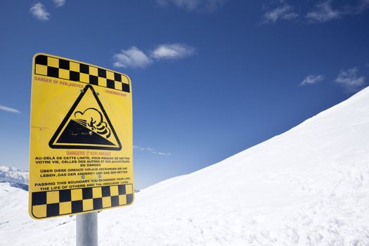 Snow ski resort caution sign on mountain
