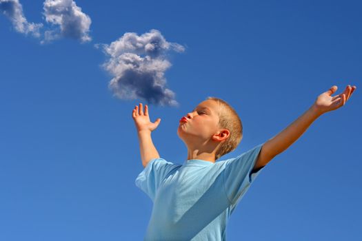 Young Boy with hands up on the Blue Sky and Cloud Background