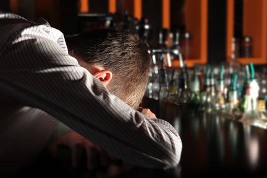 Drunken Man sleeps on the Bar counter