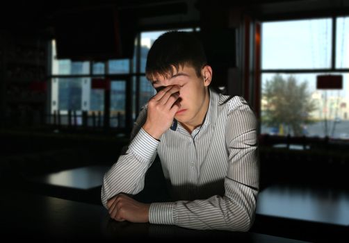 Sad and Lonely Young Man Portrait in Dark Room