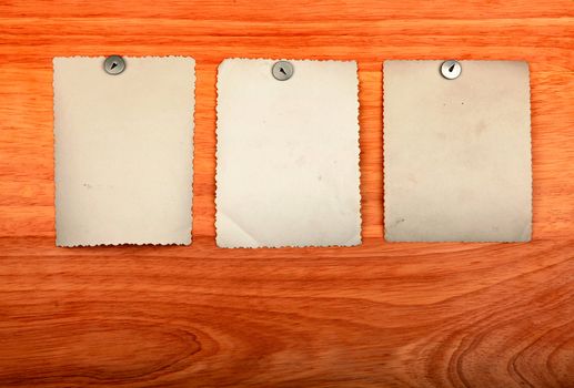 Notice Board with empty papers on old wooden wall background