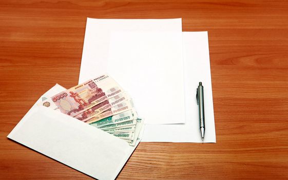 Envelope with a Russian Money and Empty Paper for Text on the Wooden Table