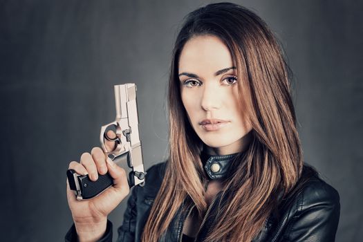 beautiful woman holding up her gun