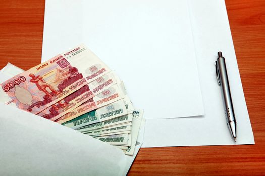 Envelope with a Russian Money and Empty Paper for Text on the Wooden Table