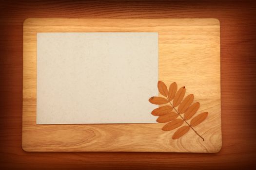 Vintage Empty Paper and Autumnal Leaf On Wooden Background