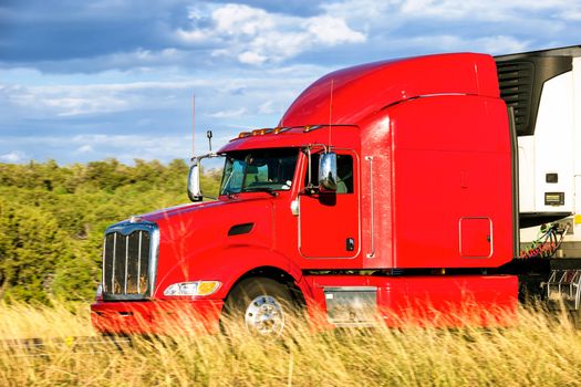 Red truck moving on a highway 