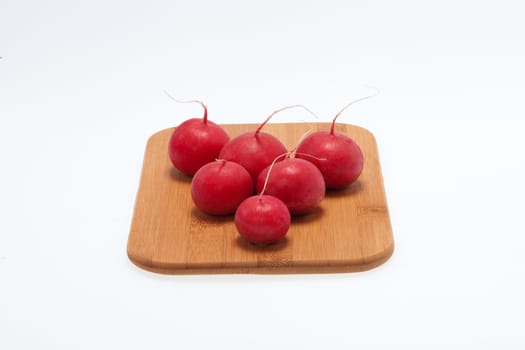 Garden radish on wooden board 