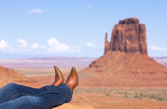 cowgirl's legs in jeans and boots at Monument Valley