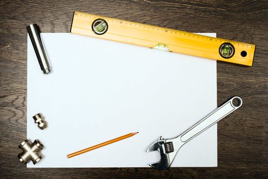 plumbing tools on a white sheet of paper, place for text