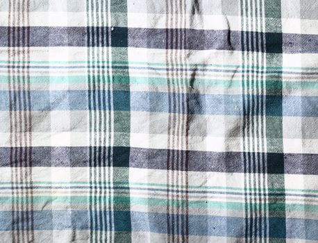 Wrinkled fabric plaid texture. Cloth background