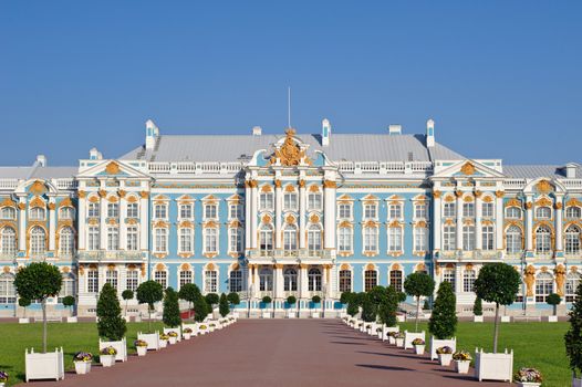 Main facade of the historic palace in the Baroque style. Blue, white and gold gamma. Summer sunny day.