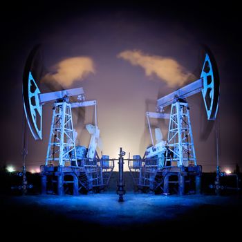 Two oil pumps jack in action. Night view. Long exposure.