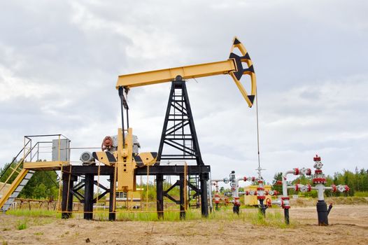 Extraction of oil. pump jack and oil well. Western Siberia. Russia.