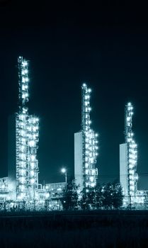 A brightly lit industrial site at night. Toned.