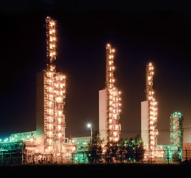 A brightly lit industrial site at night. Oil and gas industry.
