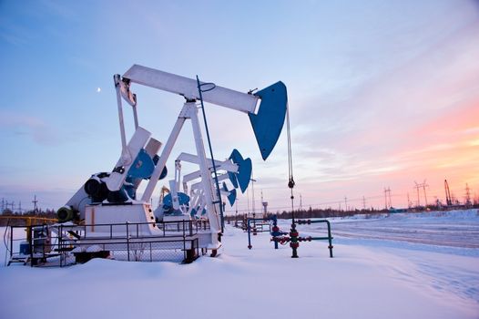 oil pumps on the sunset sky background