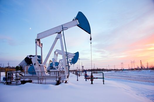 oil pumps on the sunset sky background