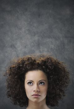 Portrait of young beautiful woman looking up