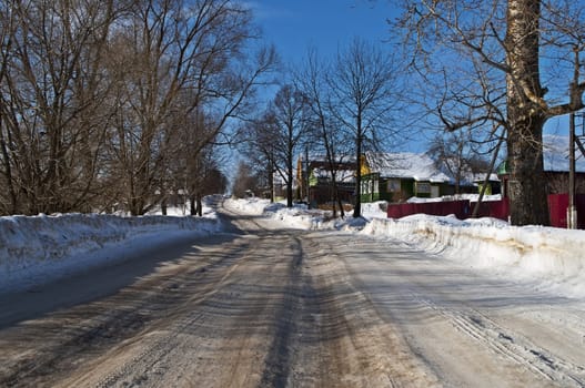 Country road covered with dirty snow