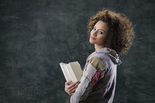 Portrait of beautiful girl student with books