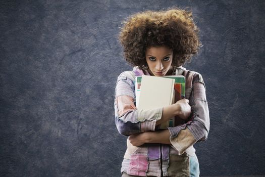 Portrait of beautiful girl student with books