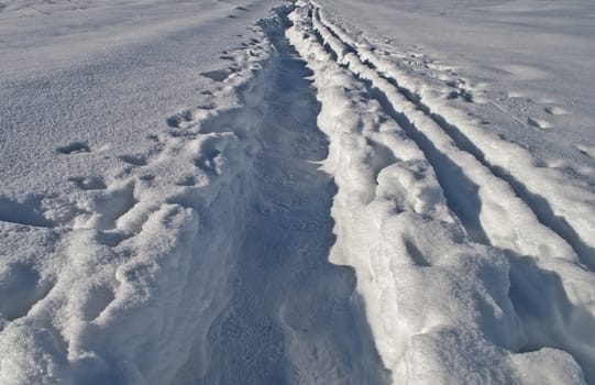 Close up of footpath in snow between snowdrifts