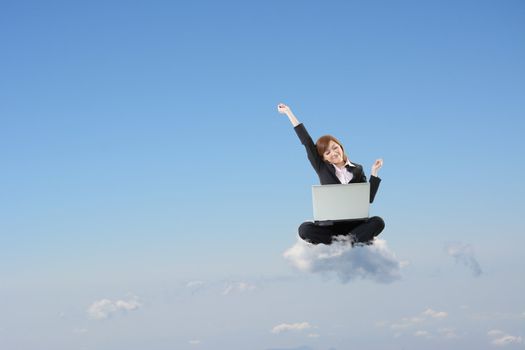 Business woman sit on cloud and use laptop over sky.