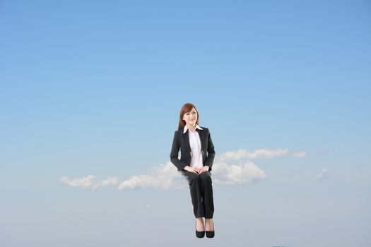 Business woman sit on cloud over blue sky.