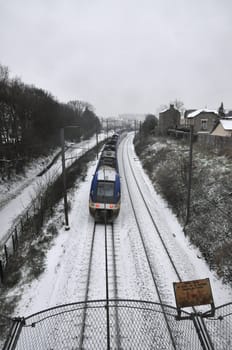 Train Passing during a Snow Day with a grey sky