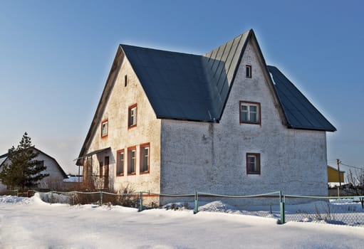 Old white stone cottage  in retro style, winter time