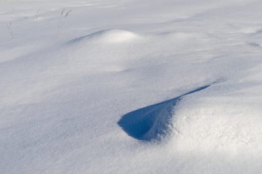 Close up of snow surface with snowdrifts, winter sunny day