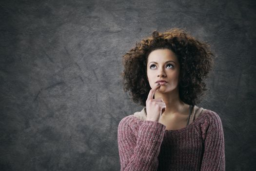 Portrait of young beautiful woman thinking