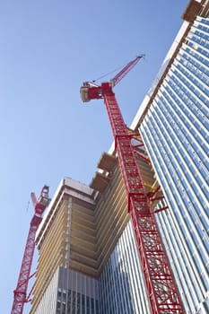 High-rise construction cranes and unfinished office
