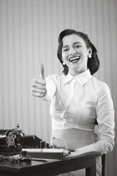Smiling office worker showing thumb up
