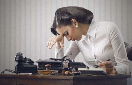 Depressed woman sitting at desk in office