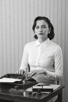 Retro business woman typing in her office