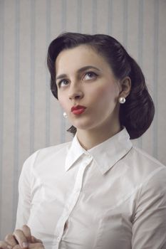 Portrait of beautiful retro business woman looking up