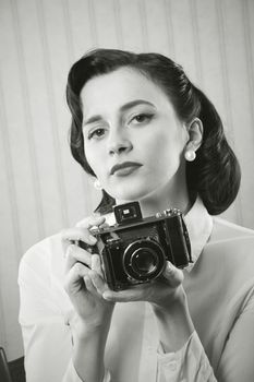 Beautiful business woman with a old camera