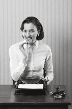 Business woman eating a cookie, break from work