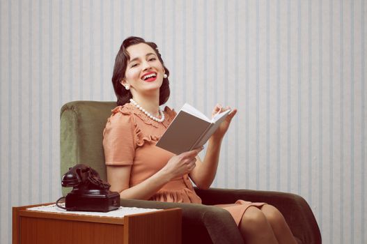 Smiling woman reading book in living room