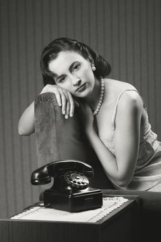 Woman wearing lingeriee waiting for the phone to ring