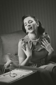 Beautiful woman using a fan to cool off