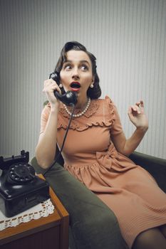 Woman talking on phone, looking surprised