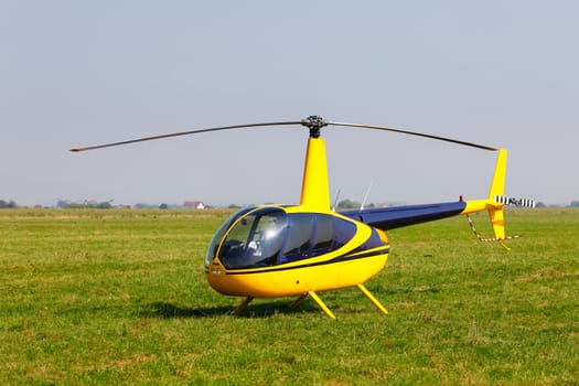 Yellow helicopter on field